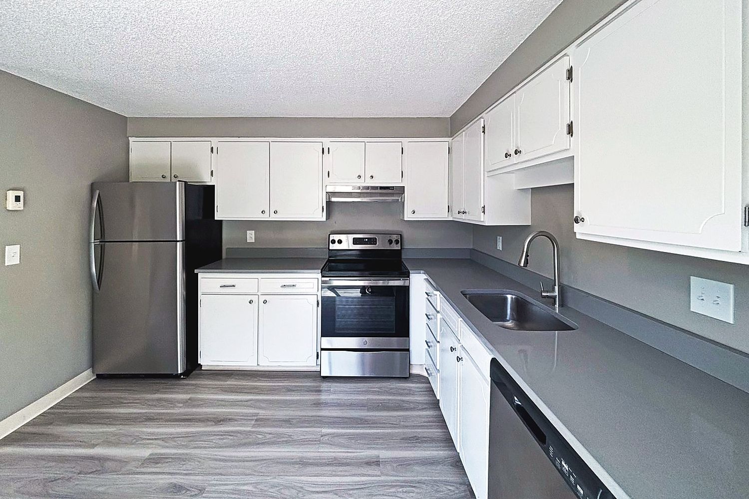 Kitchen with quartz counters, stainless appliances and a dishwasher